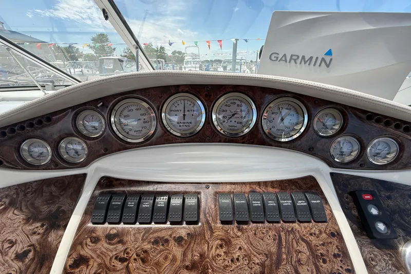 Slide: The Image of Dashboard of a 2001 Doral 330se boat with gauges and Garmin navigation system. - 16