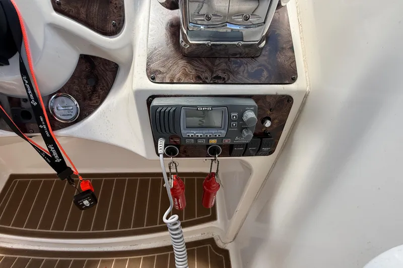 Slide: The Image of Control panel of a 2001 Doral 330se boat featuring GPS and ignition keys. - 17