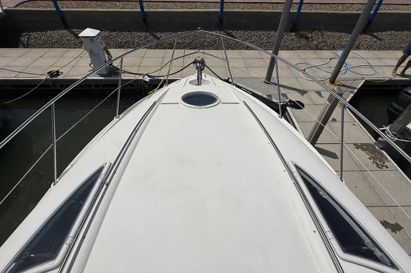 Slide: The Image of Bow view of a 2001 Doral 330se boat docked at a marina. - 21