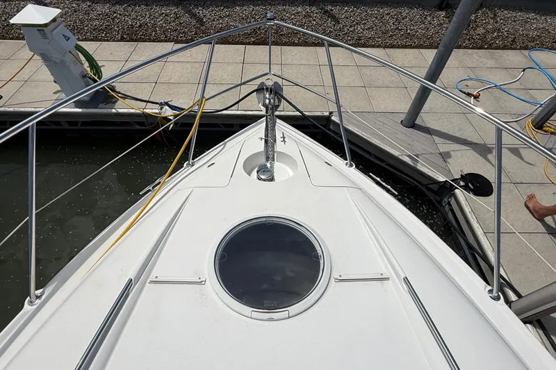 Slide: The Image of Bow view of a 2001 Doral 330se boat docked at a marina. - 22