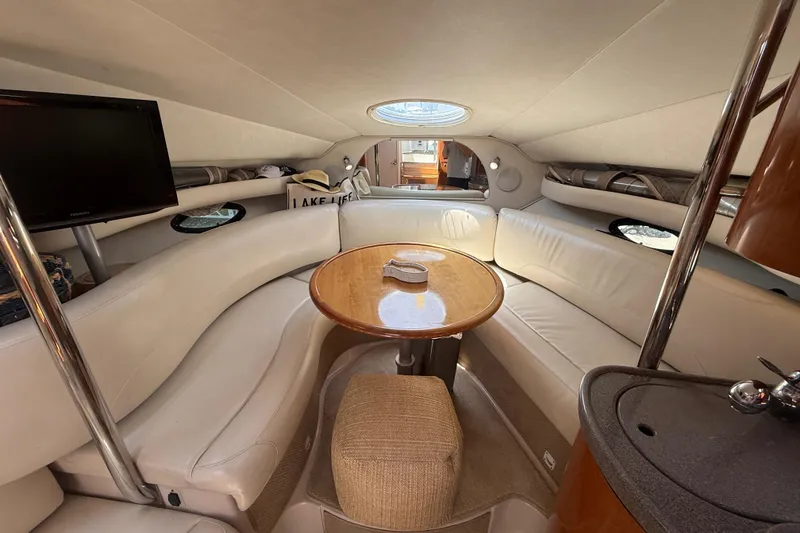 Slide: The Image of Interior of 2001 Doral 330se yacht with cozy seating and wooden table. - 26