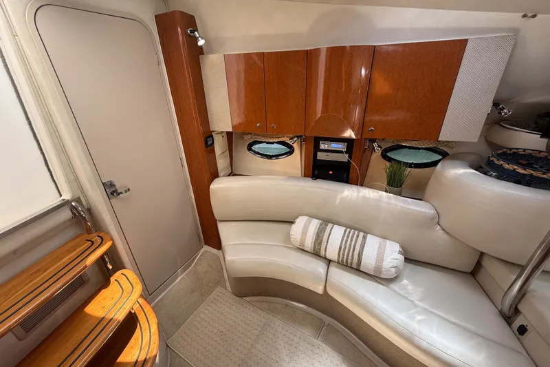 Slide: The Image of Interior of 2001 Doral 330se boat with white seating and wooden cabinets. - 27