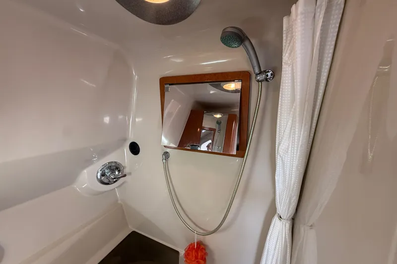 Slide: The Image of Bathroom interior of a 2001 Doral 330se boat with shower and mirror. - 32