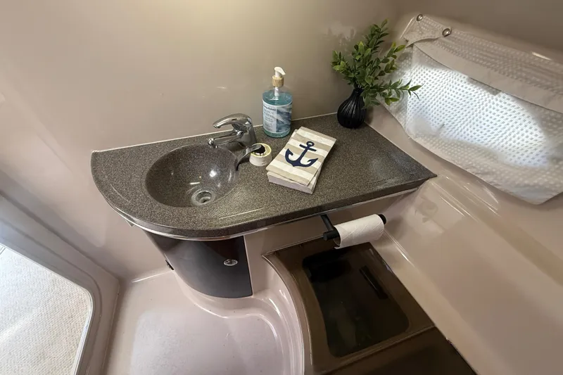Slide: The Image of Bathroom sink area in a 2001 Doral 330se boat with nautical decor. - 34