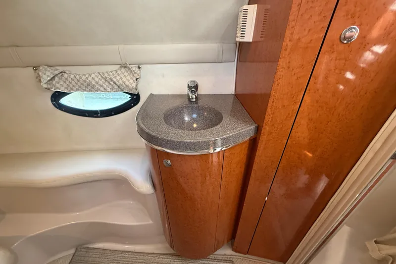 Slide: The Image of 2001 Doral 330se boat interior with wooden cabinetry and compact sink. - 36