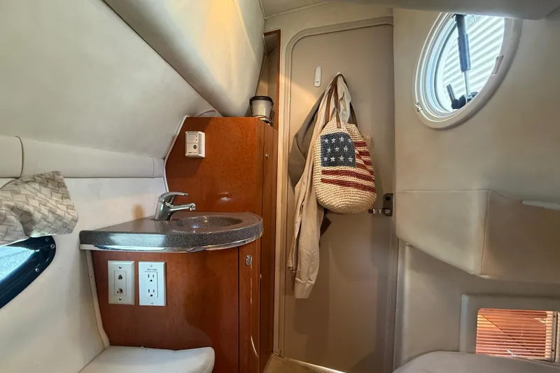 Slide: The Image of Interior of a 2001 Doral 330se boat featuring a compact sink and storage area. - 39
