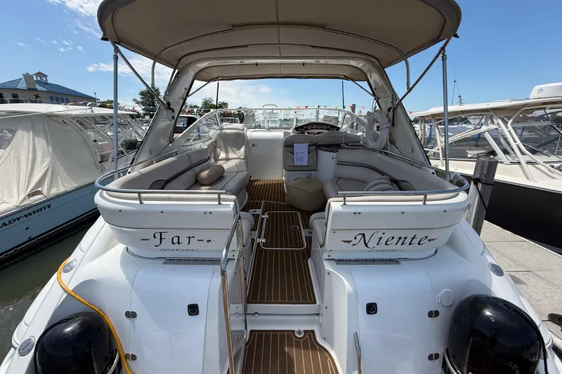 Slide: The Image of 2001 Doral 330se yacht docked, featuring spacious seating and elegant design. - 4