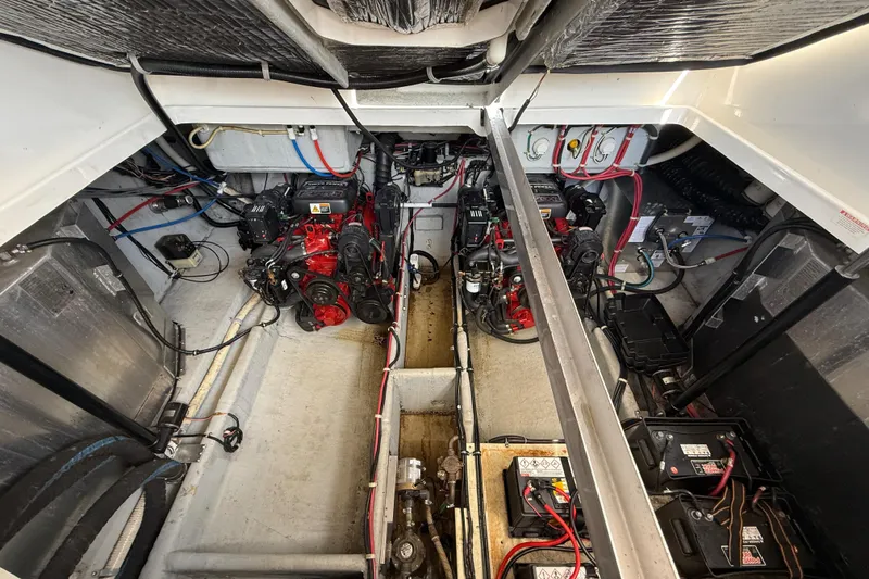 Slide: The Image of Engine compartment of a 2001 Doral 330se boat, showcasing dual engines and wiring. - 40