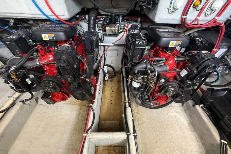 Slide: The Image of Engine compartment of a 2001 Doral 330se boat, featuring dual red engines. - 41