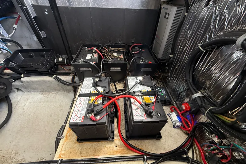 Slide: The Image of Battery compartment of a 2001 Doral 330se boat with wiring and connections. - 44