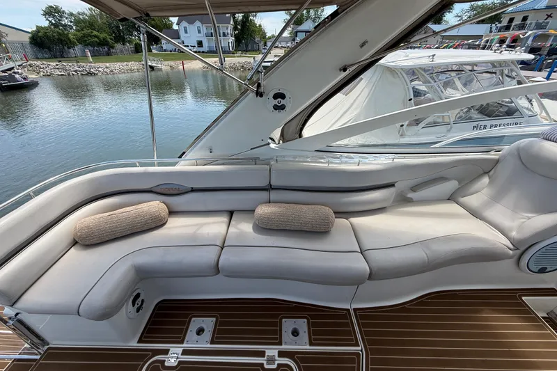 Slide: The Image of Luxury seating area on a 2001 Doral 330se yacht, docked by a serene waterfront. - 8