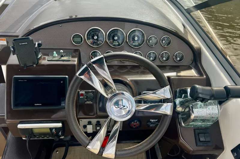 Slide: The Image of Dashboard of a 2015 Regal 30 Express boat with steering wheel and navigation instruments. - 18