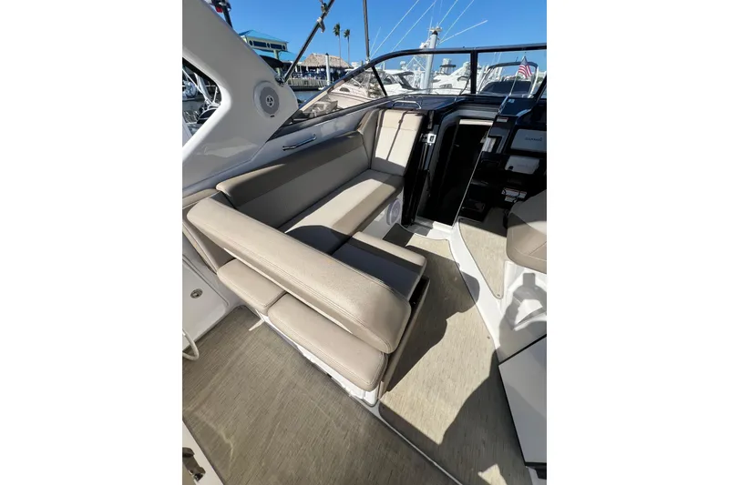 Slide: The Image of Interior of a 2015 Regal 30 Express boat with beige seating and modern design. - 11