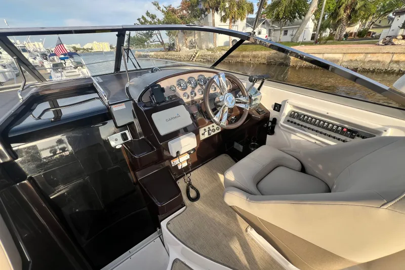 Slide: The Image of 2015 Regal 30 Express boat cockpit with steering wheel and control panel. - 14