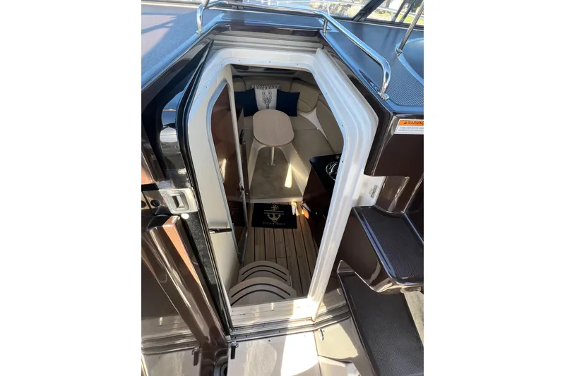 Slide: The Image of Interior view of 2015 Regal 30 Express boat cabin with seating and table. - 15