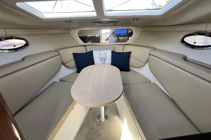 Slide: The Image of Interior of 2015 Regal 30 Express boat with beige seating and skylights. - 16