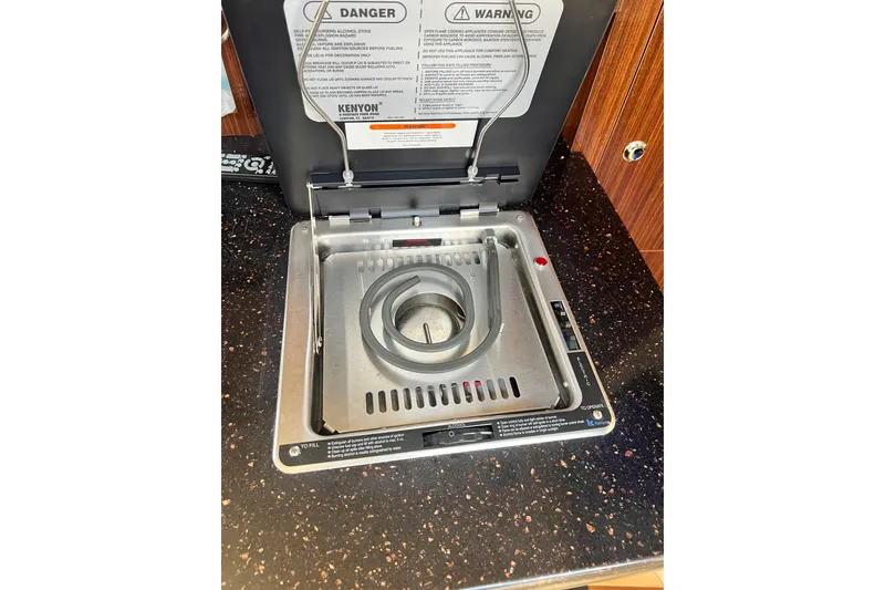 Slide: The Image of Built-in stove on 2015 Regal 30 Express boat, featuring a single burner. - 17