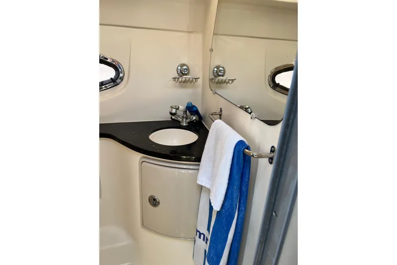 Slide: The Image of Bathroom interior of 2015 Regal 30 Express boat with sink and towels. - 21