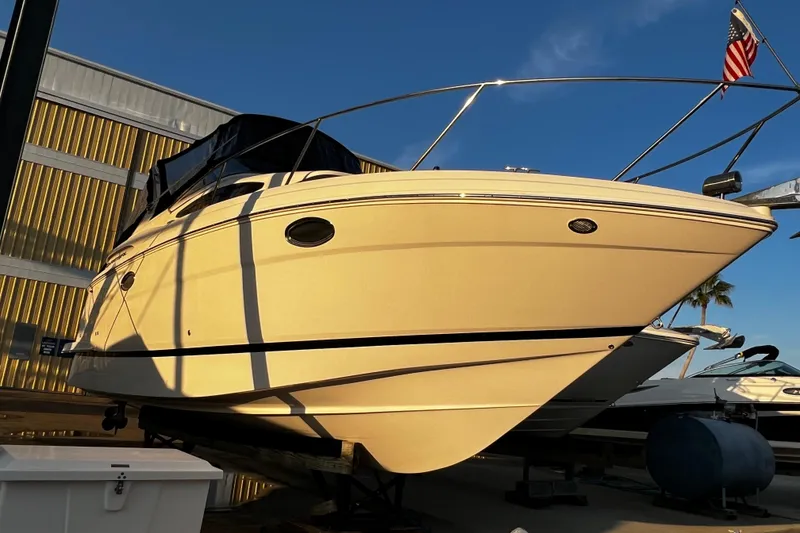 Slide: The Image of 2015 Regal 30 Express boat docked with American flag, under clear blue sky. - 4