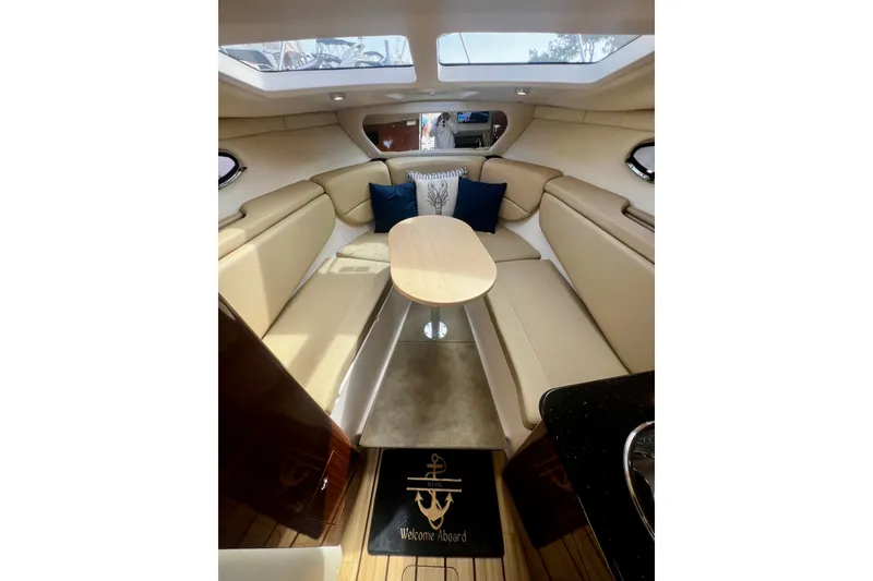 Slide: The Image of Luxurious interior of 2015 Regal 30 Express yacht with beige seating and elegant decor. - 21