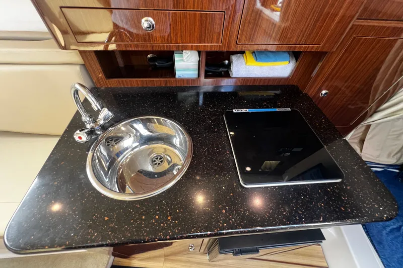 Slide: The Image of Luxurious galley in 2015 Regal 30 Express boat with sink and cooktop. - 25