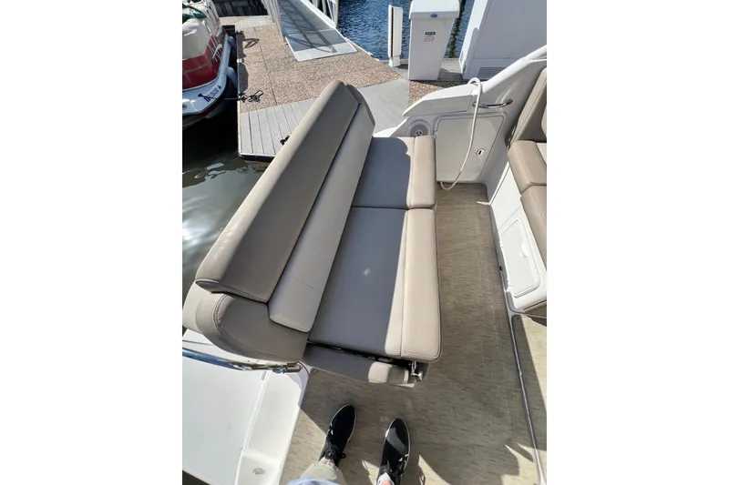 Slide: The Image of 2015 Regal 30 Express boat interior with beige seating and dock view. - 14