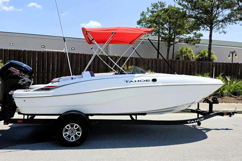 The Image of 2026 Tahoe T18 boat with red canopy on trailer, parked outdoors. - 0