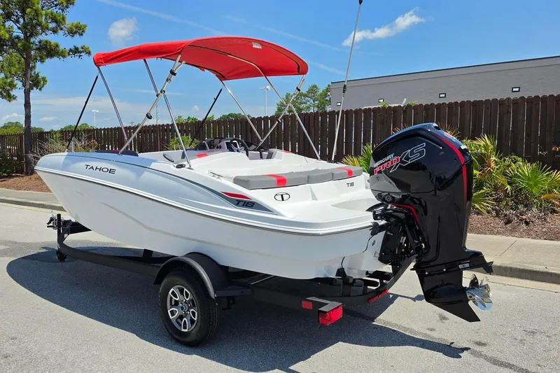Slide: The Image of 2026 Tahoe T18 boat with red canopy and Mercury engine on trailer. - 11