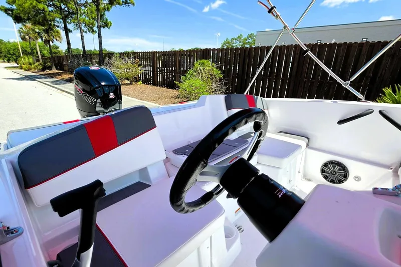 Slide: The Image of 2026 Tahoe T18 boat interior with steering wheel and seating, featuring modern design elements. - 14