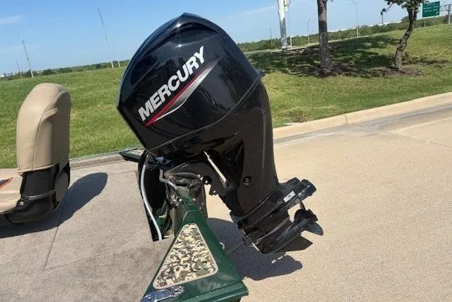 Slide: The Image of 2026 Tracker Bass Tracker Classic Limited with Mercury outboard motor on a sunny day. - 2