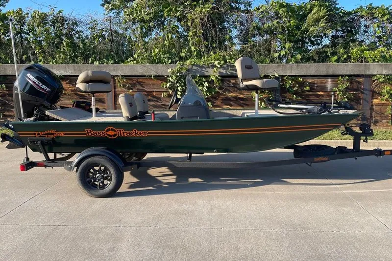 The Image of 2026 Tracker Bass Tracker Classic Limited fishing boat on trailer, outdoors. - 0