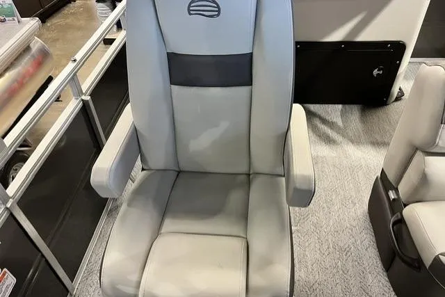 Slide: The Image of 2026 Sun Tracker Fishin' Barge 20 DLX boat seat, gray upholstery, armrests, and logo detail. - 3