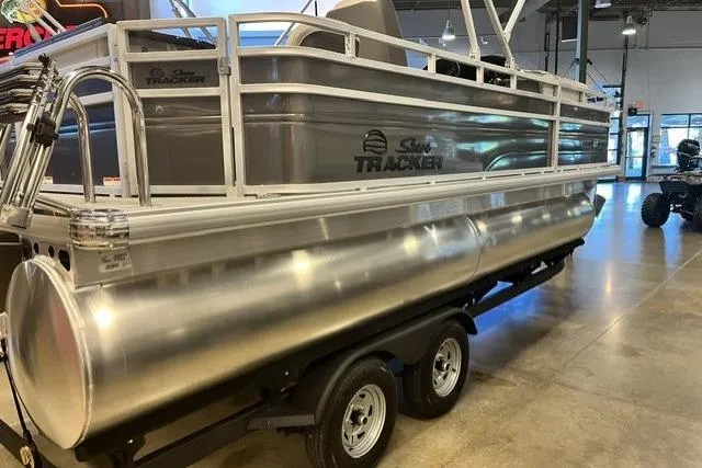 Slide: The Image of 2026 Sun Tracker Fishin' Barge 20 DLX pontoon boat on display indoors. - 1