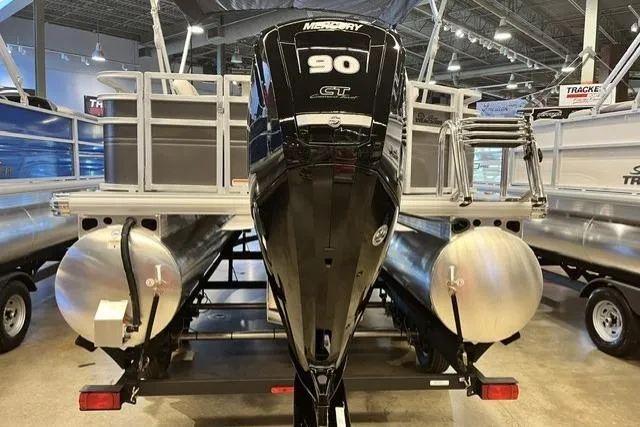 Slide: The Image of 2026 Sun Tracker Fishin' Barge 20 DLX with Mercury 90 engine in showroom. - 2