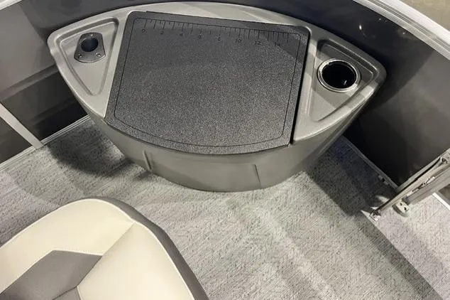 Slide: The Image of 2026 Sun Tracker Fishin' Barge 20 DLX interior with cup holder and storage compartment. - 105