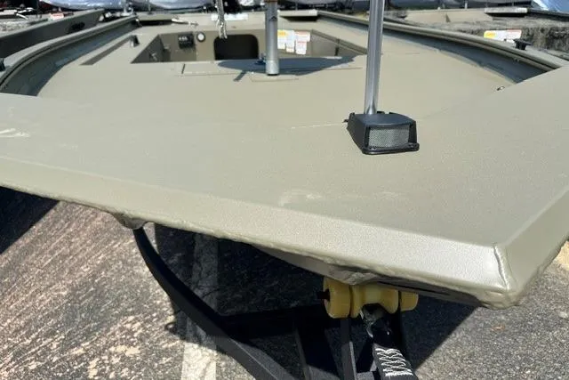 Slide: The Image of 2026 Tracker Grizzly 1654 T Sportsman boat, close-up of bow on trailer. - 10
