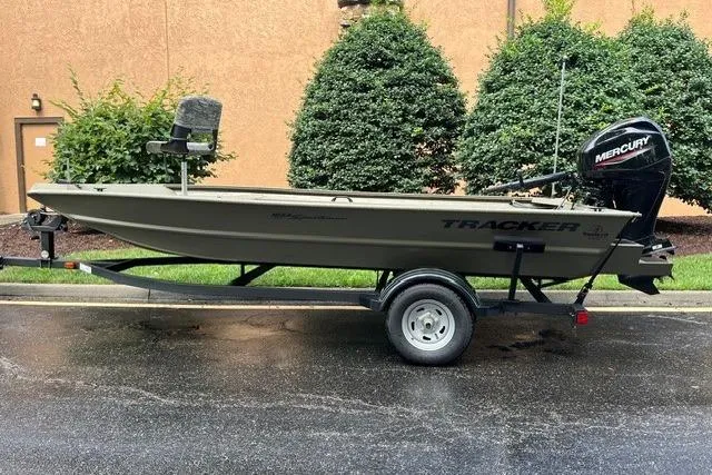 The Image of 2026 Tracker Grizzly 1654 T Sportsman boat on trailer, parked outdoors. - 0
