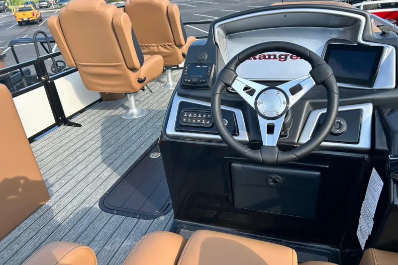 Slide: The Image of Interior of 2026 Ranger 223FC boat with modern steering and tan seating. - 16