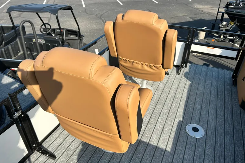 Slide: The Image of 2026 Ranger 223FC boat with tan seats on a textured deck. - 13