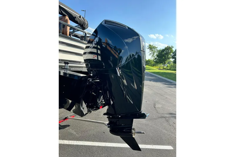 Slide: The Image of 2026 Ranger 223FC boat with sleek black outboard motor in sunny outdoor setting. - 4