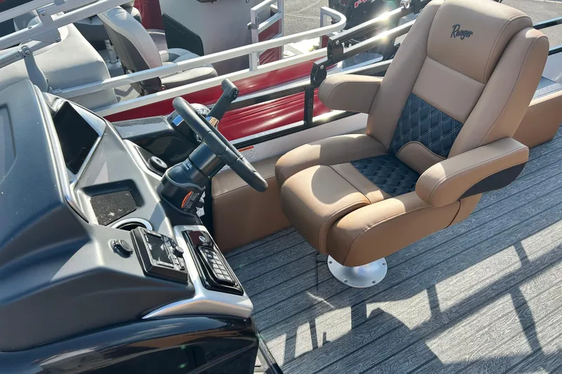 Slide: The Image of Captain's chair and helm of 2026 Ranger 223FC boat, featuring modern controls and design. - 11