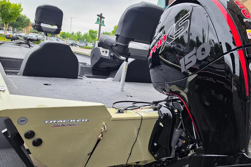 Slide: The Image of 2026 Tracker Pro Team 195 boat with Mercury Pro XS 150 engine in a parking lot. - 4
