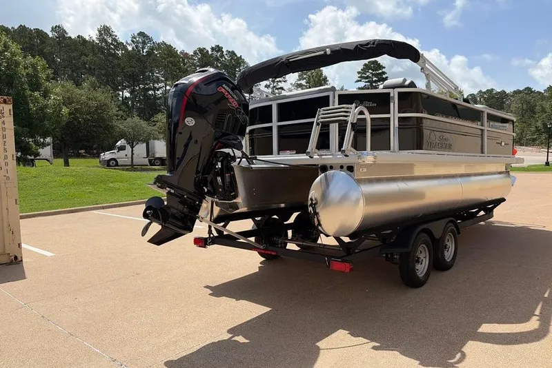 Slide: The Image of 2026 Sun Tracker Party Barge 20 DLX pontoon boat on trailer, parked outdoors. - 5