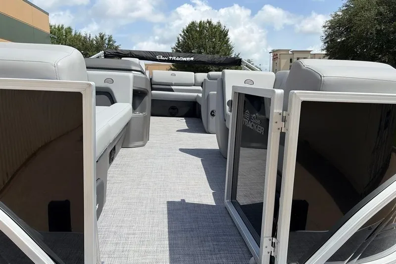 Slide: The Image of 2026 Sun Tracker Party Barge 20 DLX interior with open gates and seating. - 6
