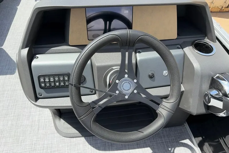 Slide: The Image of Steering console of 2026 Sun Tracker Party Barge 20 DLX with modern controls. - 9