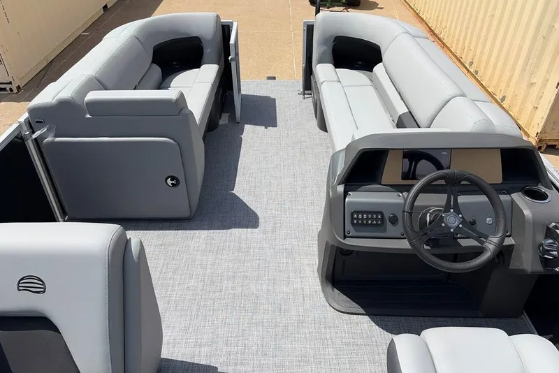 Slide: The Image of 2026 Sun Tracker Party Barge 20 DLX interior with gray seating and modern helm. - 8