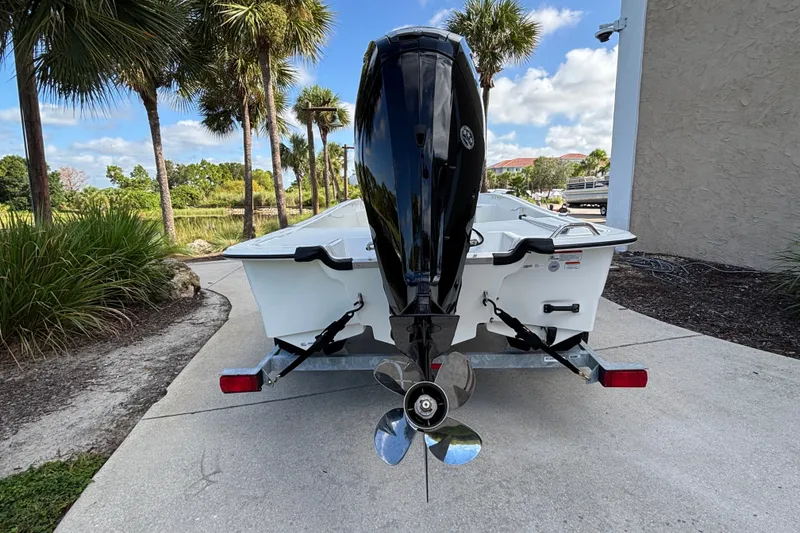 Slide: The Image of 2026 Mako Pro Skiff 17 CC boat on trailer, rear view with outboard motor. - 3