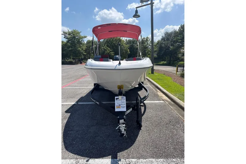 Slide: The Image of 2026 Tahoe T18 boat on trailer with red canopy in sunny parking lot. - 3