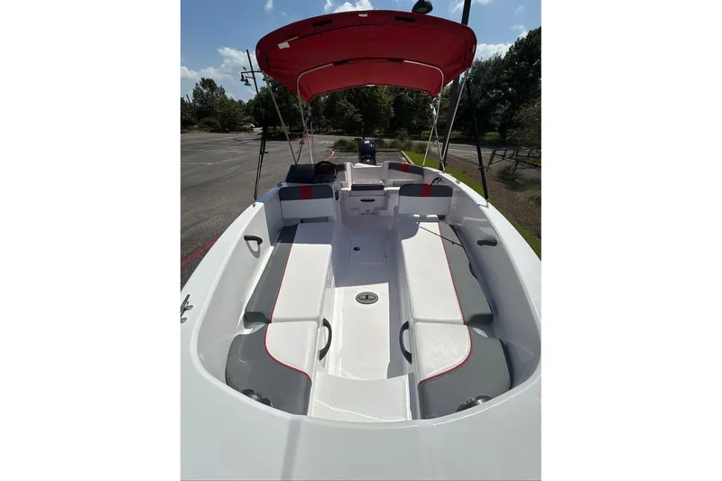 Slide: The Image of 2026 Tahoe T18 boat interior with red canopy, spacious seating, and sleek design. - 4