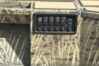 Slide: The Image of 2026 Tracker Grizzly 1756 T Marsh boat control panel with camouflage design. - 3